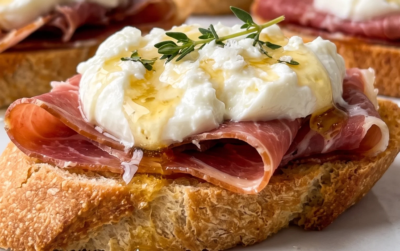 Beef Prosciutto Crostini with Burrata and Lemon Honey Drizzle