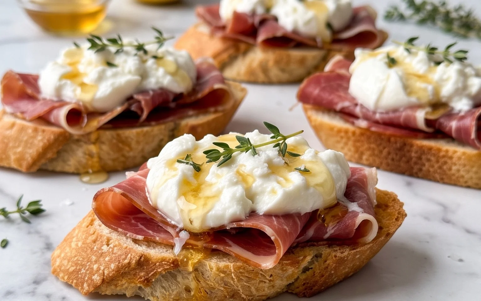 Beef Prosciutto Crostini with Burrata and Lemon Honey Drizzle